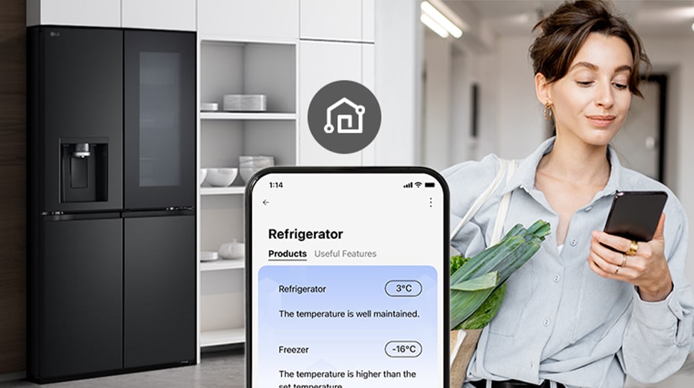 Woman with shopping basket looking at her cell phone, controlling the refrigerator remotely.