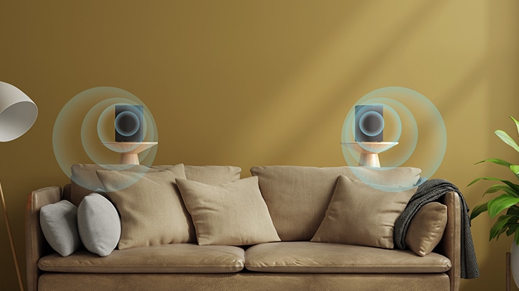 Rear speakers behind a sofa with virtual surround sound effect.