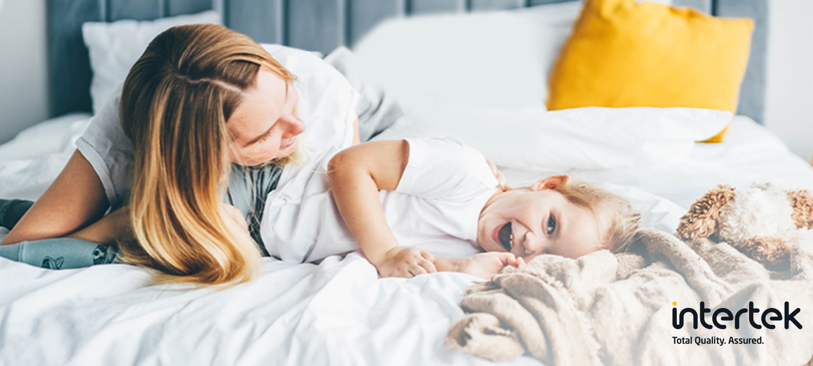 Mother and child on a clean bed - Allergy Care with Intertek certification